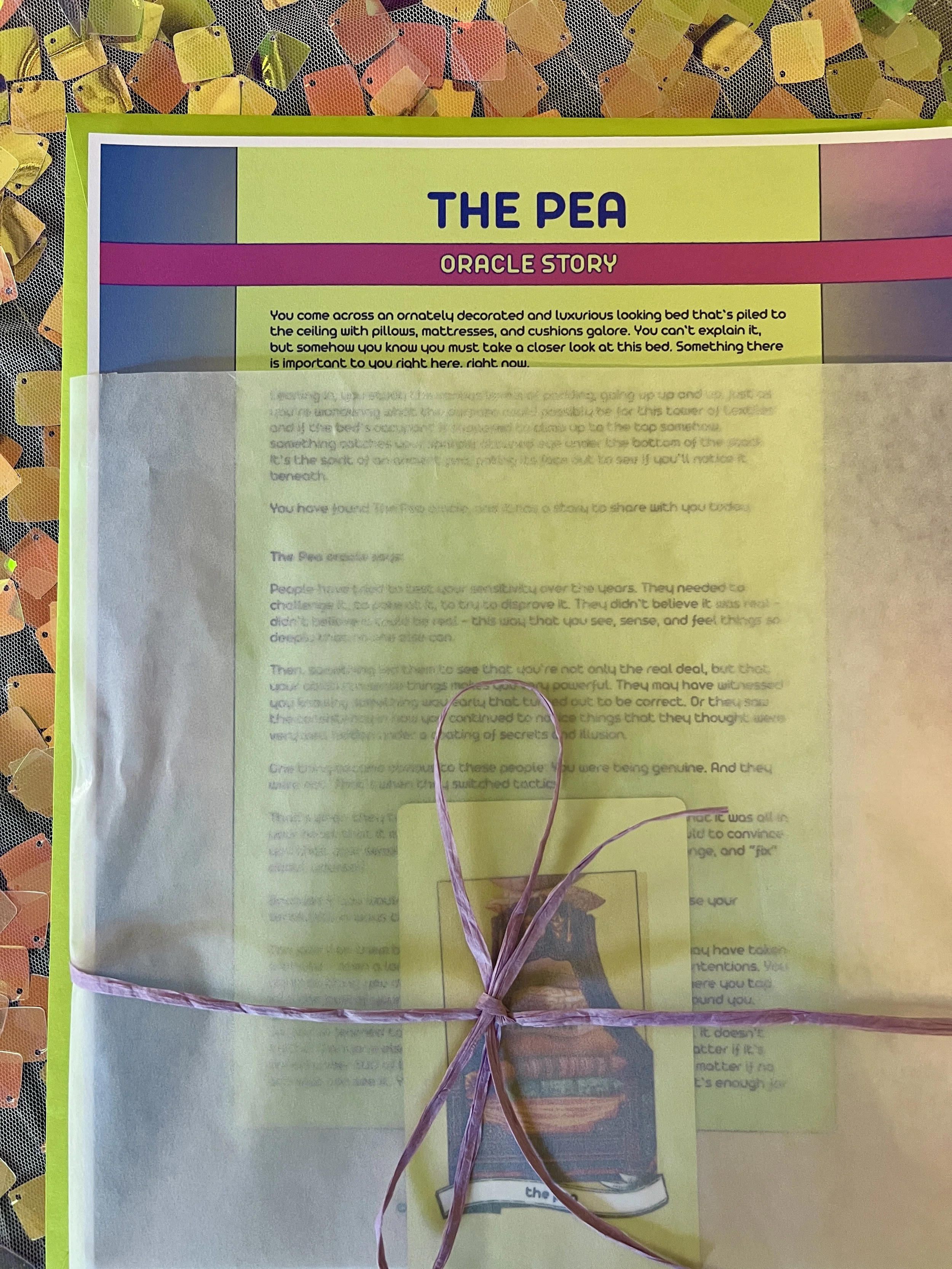 The Pea from Found Oracles printed story sheet peeking out of its glassine sleeve with story card visible inside.