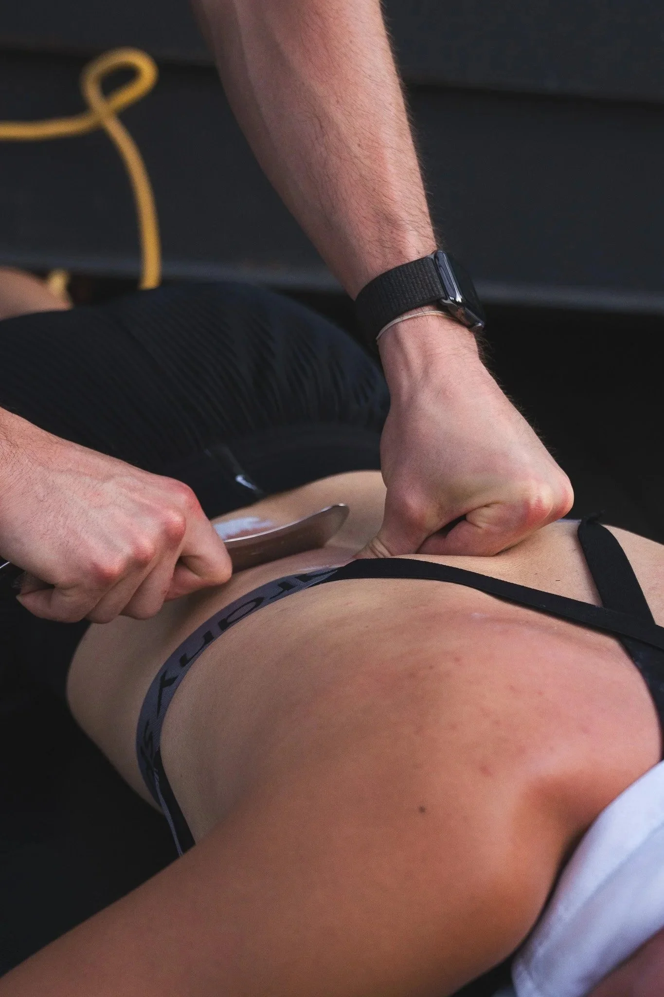 muscle scraping or IASTM Therapy being done on a persons back by their chiropractor
