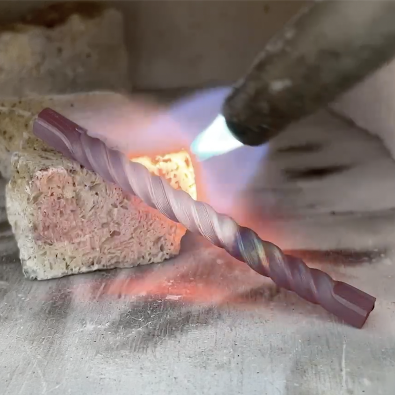 Annealing twisted mokume rod.