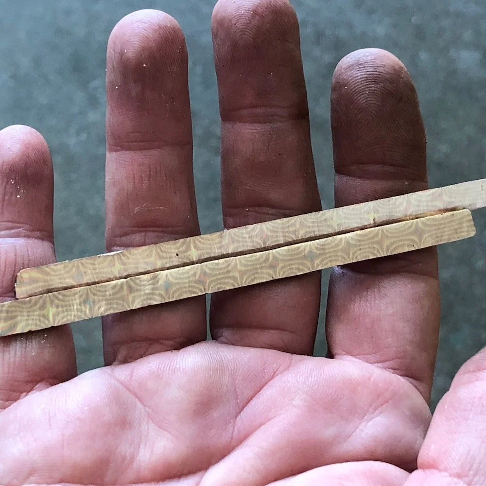 This tightly twisted rod has been sawn in half to reveal the star pattern inside.