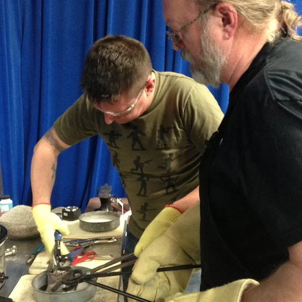 Chris and Jim unwrap a red-hot billet from its protective wrap.