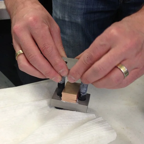 Carefully carefully stacking the layers into the torque plate assembly.