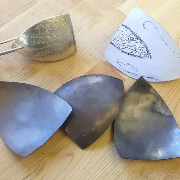 All three sides, formed and close to the final shape. They are dark now since they've been annealed.