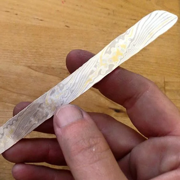 The pattern emerges as I file and sand off the 'stamp bumps.'