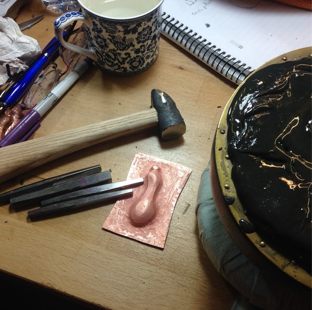  After a few rounds of putting the piece in the pitch then punching down around the outline, a good gourd shape appeared! The trick is to use the tools in such a way as to 'squish' the metal in, sweep it up towards the shape while moving it down. Ver