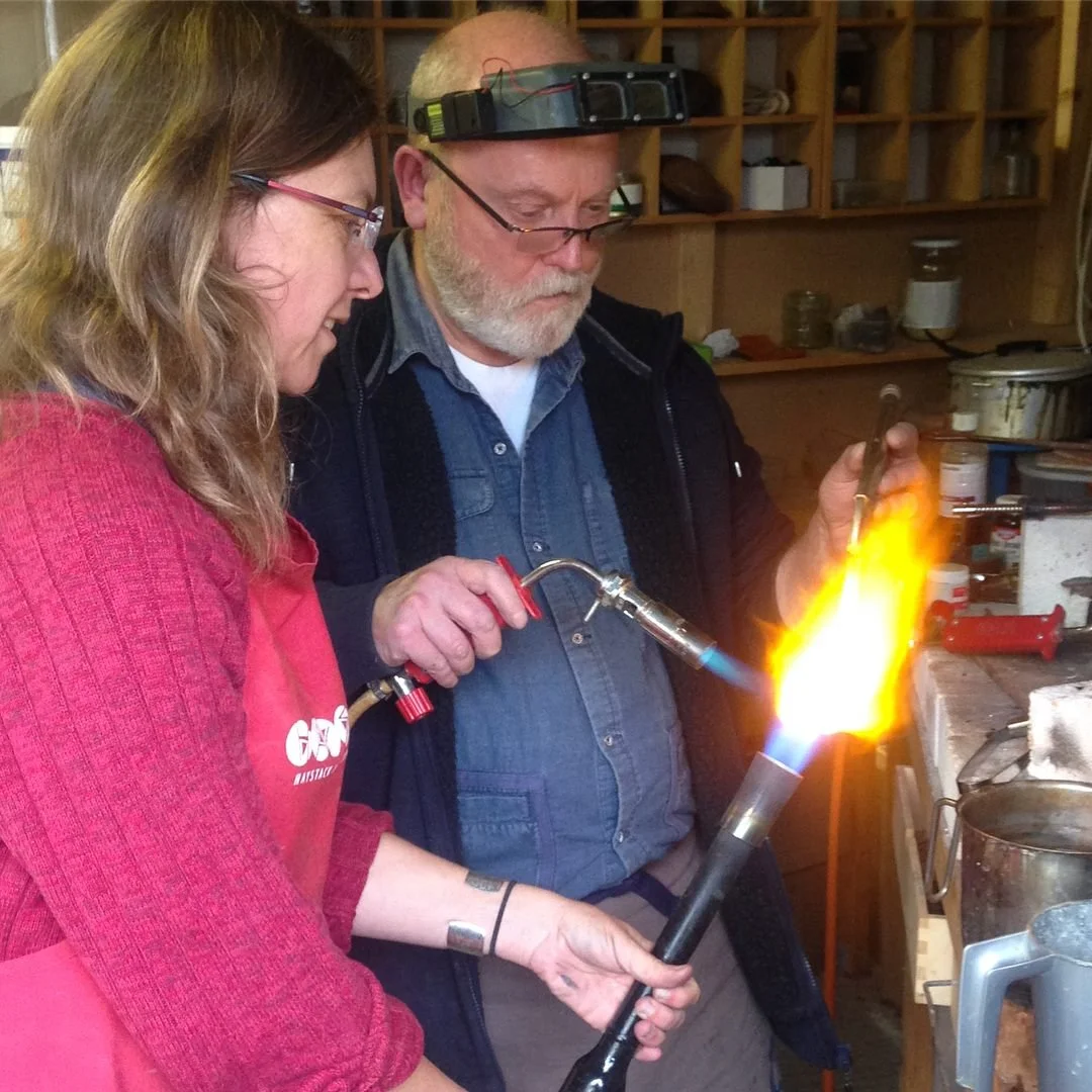  Here we've got the gourd cradled in a re-purposed steel fork, with torches either side to form a reducing atmosphere. Went to screaming hot, not just annealing temp here. 