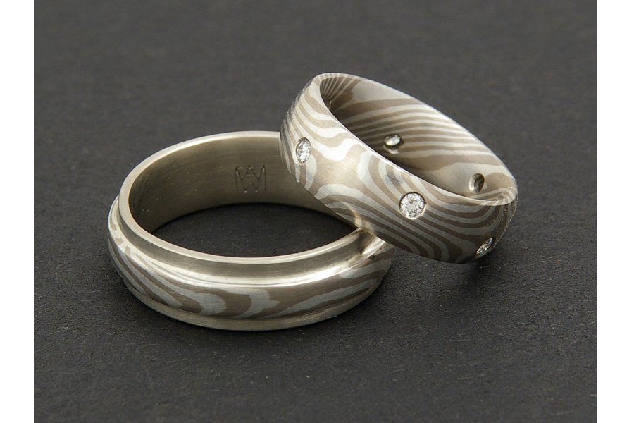 This was an older set of mine, probably only the third pair of mokume gane rings I ever made. The strip of mokume on a white gold band makes a nice accent to match the star-patterned ring with flush-set diamonds . Material - 14k palladium white gold 
