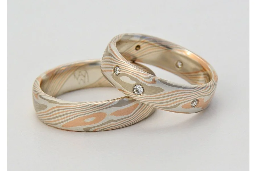 This couple wanted a shape less traditional than the low-dome, but didn't want the strong geometric feel of the flat-top. So, flat with slightly rounded edges was born! I think this is a great shape to accentuate the patterning. Metals combination WR