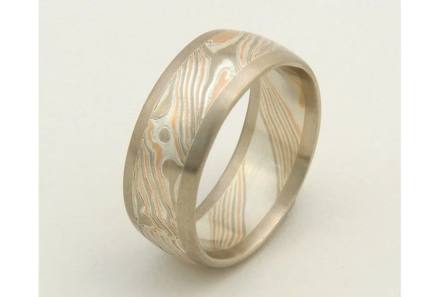 Tsuchi (Earth) ~ Central core of mokume, with patterning that mirrors the complex metamorphic and topological patterns of our planet. Visually grounded and framed with rose, yellow or white gold edging. Looks best from 6 to 8mm wide.