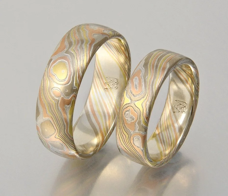 Color Choice PYRS - one of my newest color combinations- 18k yellow gold, palladium 500, 14k rose gold, all layered with thinner layers of sterling silver. This set is etched, with one ring domed, one flat-top.