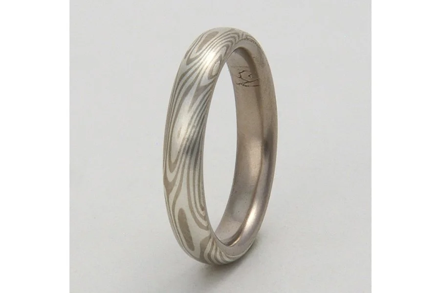 This ring uses 14k palladium white gold and sterling silver for the mokume gane (WS), but with a generous 18k palladium white gold lining. The customer was allergic to many metals, so using the 18k lining minimized the chance of any reaction. And it 