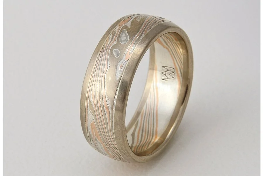 Tsuchi (Earth) ~ Central core of mokume, with patterning that mirrors the complex metamorphic and topological patterns of our planet. Visually grounded and framed with rose, yellow or white gold edging. Looks best from 6 to 8mm wide.