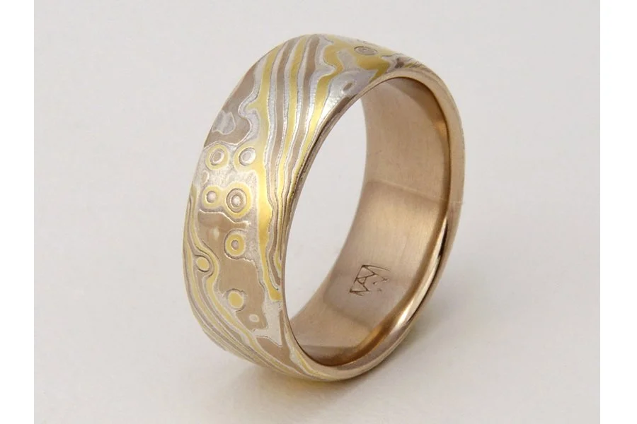 Mizu (Water) ~ Flowing, organic lines and swirls represent the changing flow of water in river, lake, surf and sea. This style is always lined with solid rose, yellow or white gold. Looks great from 4mm up to 9mm wide. This option uses 14k palladium 