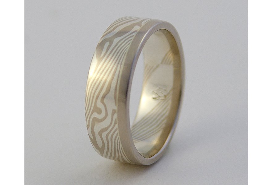 Kaze (Wind) ~ Swirling lines of mokume resemble the path of a breeze moving through trees. One solid edge of gold (rose, yellow or white) calms and anchors the design. Available from 5 to 8mm wide. This selection is sterling silver and 14k palladium 