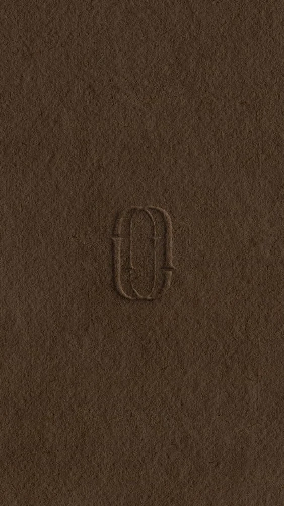 Close-up of a textured brown surface with a small embossed zero (0) in the center.