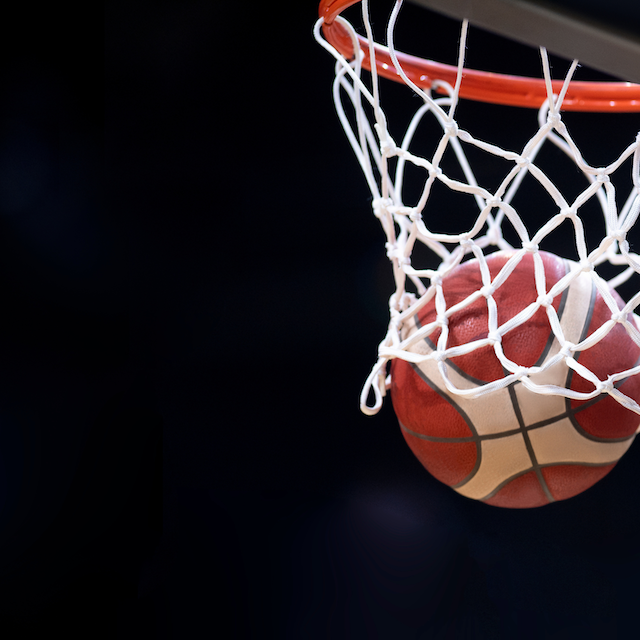 Basketball hoop with a basketball going through the net