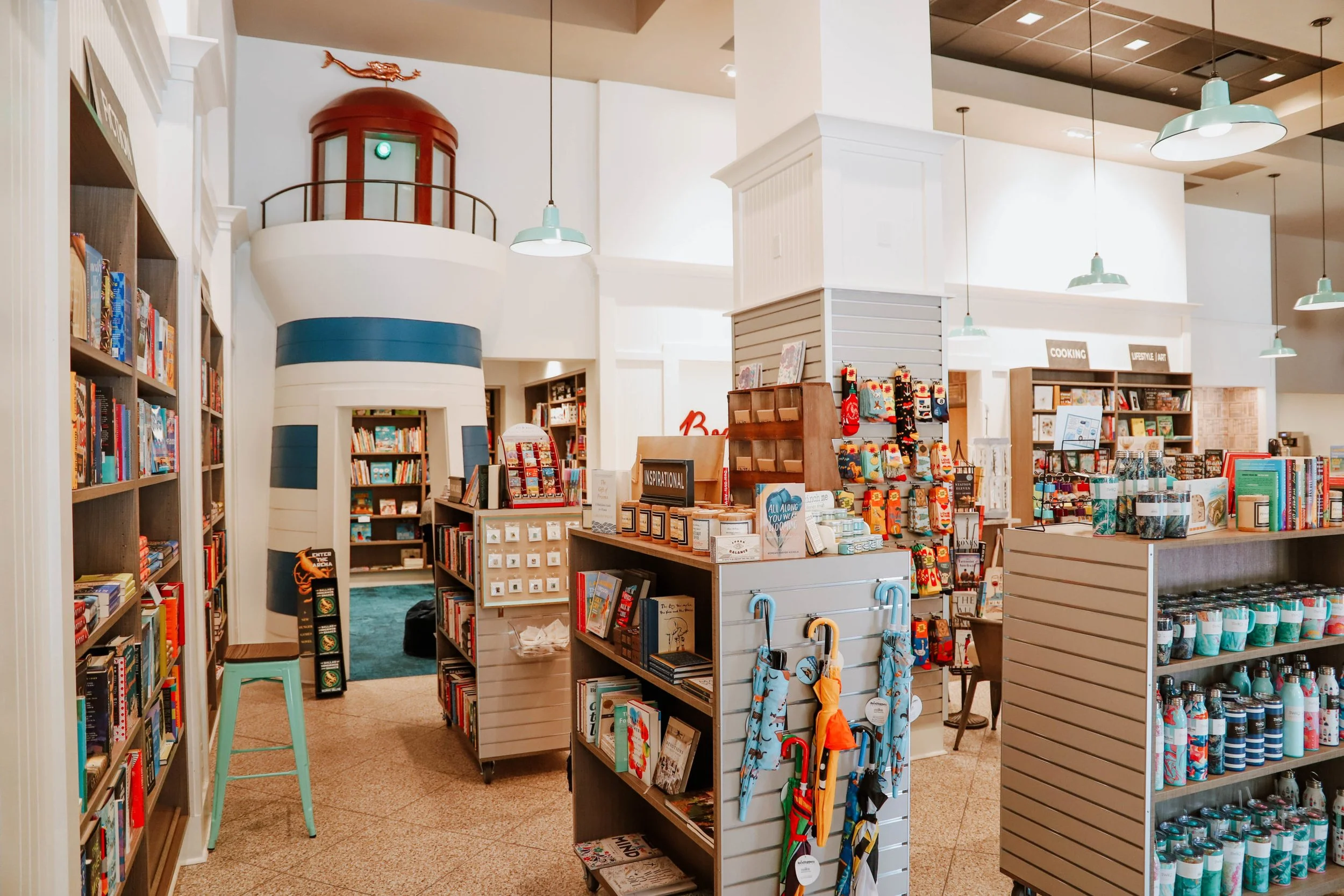 Bodacious Bookstore & Cafe interior with lots of books for sale on the shelves and umbrellas and other merchandise