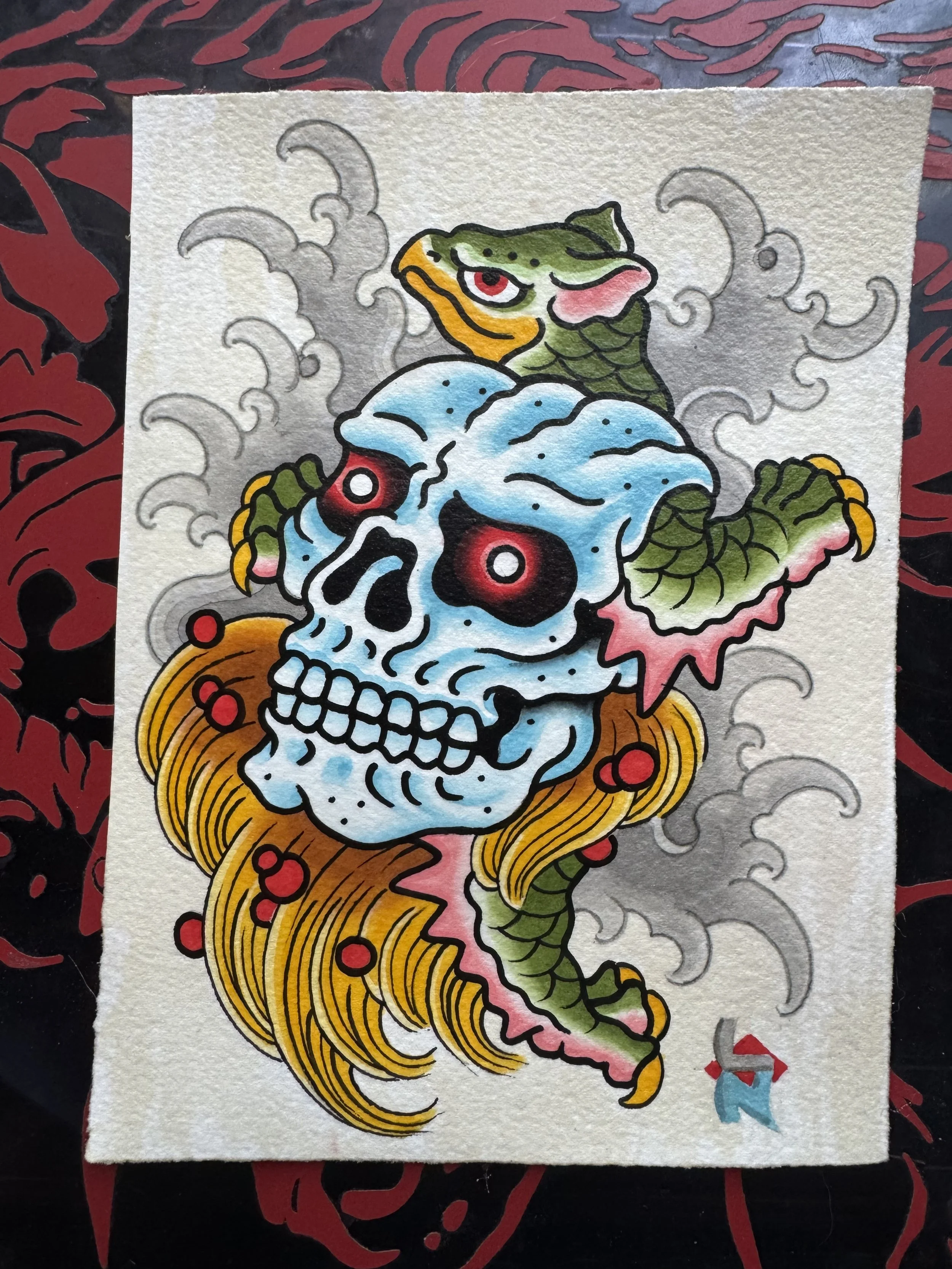 Tattoo-style illustration of a minogame turtle, a skull with blue shading, with green scales, pink accents, and yellow claws, with smoke-like water in the background and red accents.