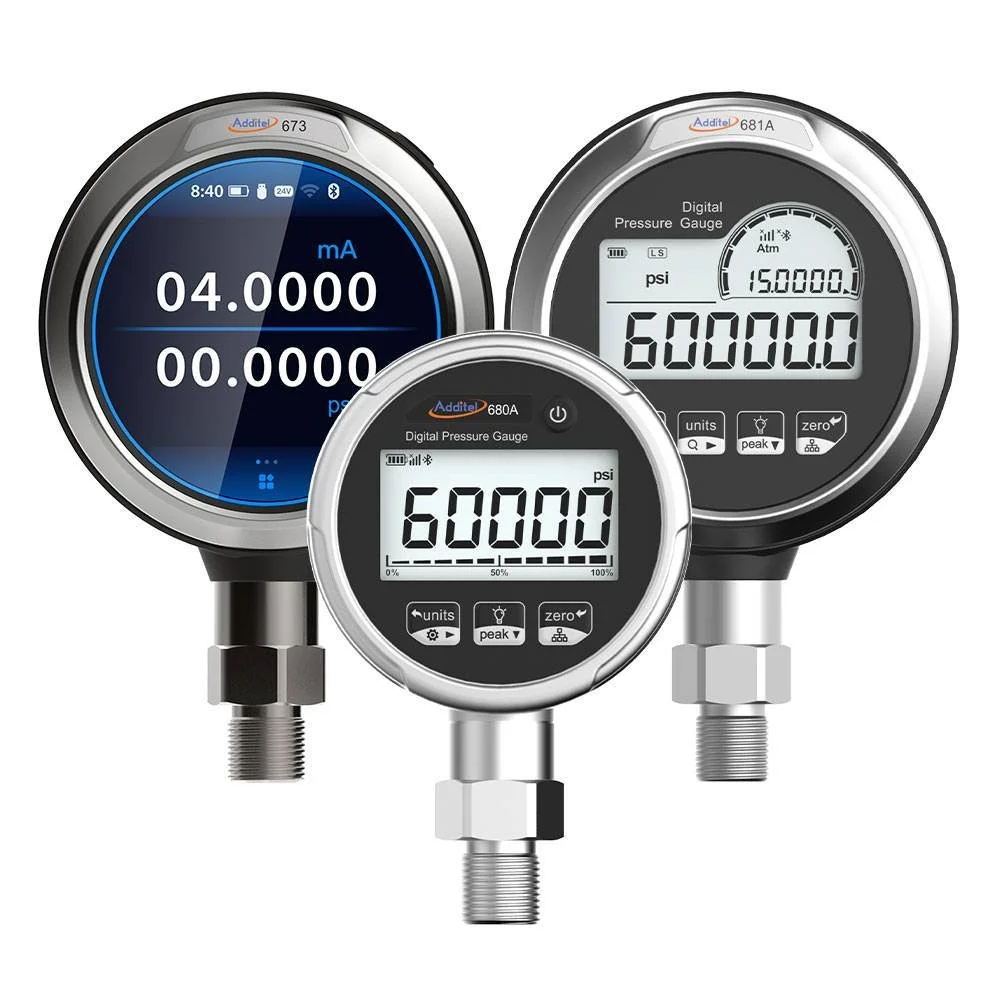 Three digital pressure gauges with black, silver, and white faces, showing pressure readings of 15 psi, 600 psi, and 600 psi, respectively, with various control buttons and connectors.