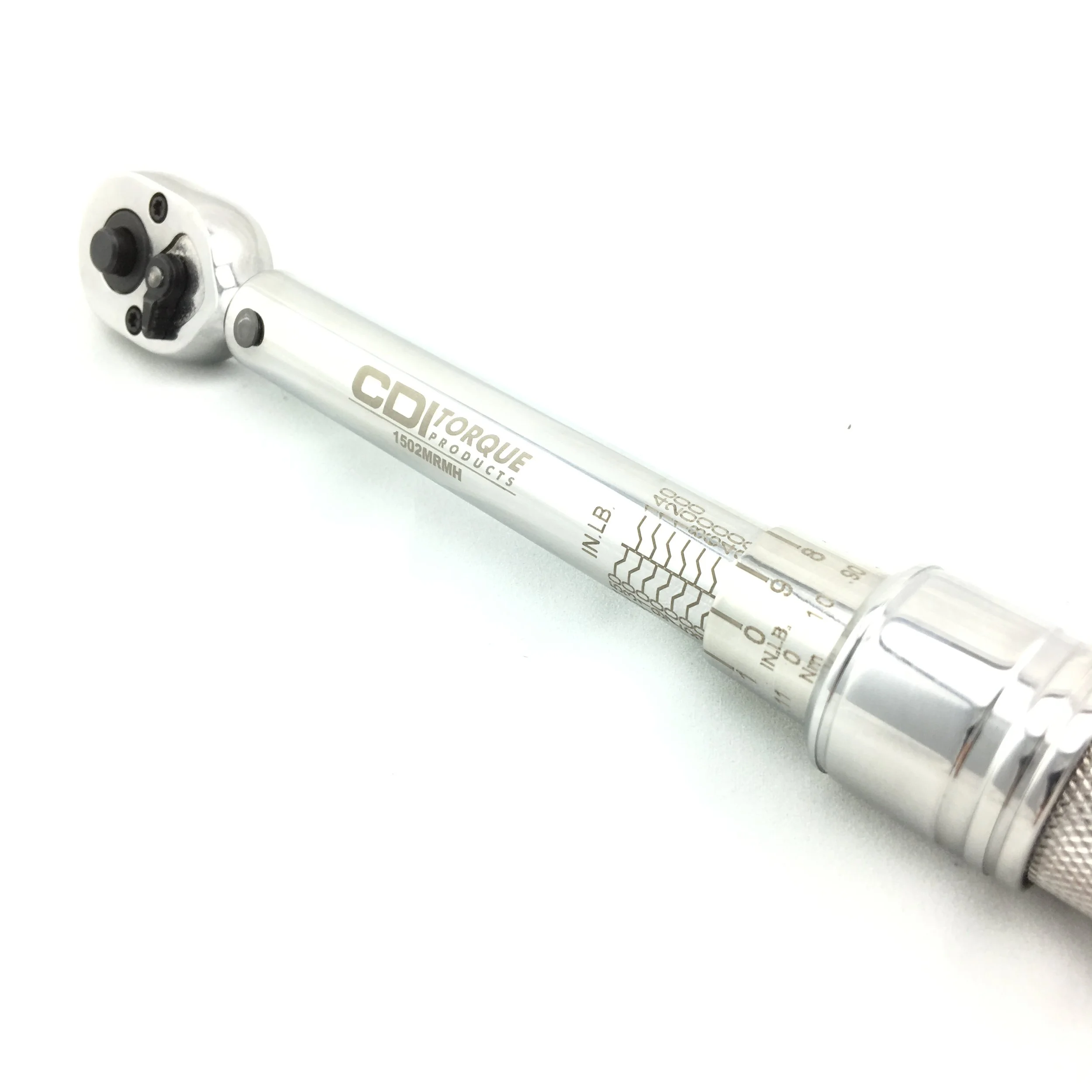 A silver torque wrench with measurement markings and a black adjustable head, laying on a white surface.