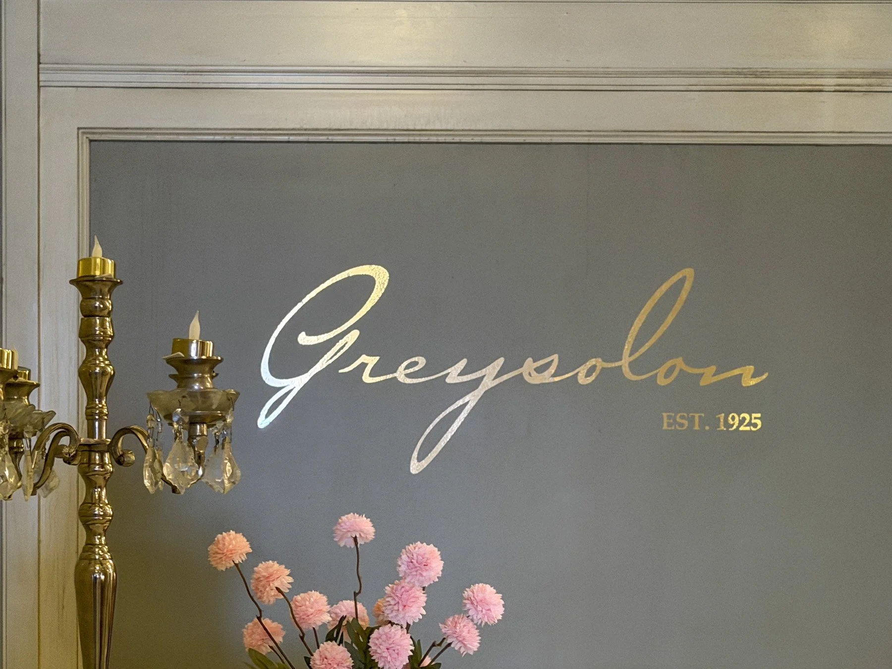Greysolon established in 1925 sign near the grand ballroom with gold reflective paint on the wall