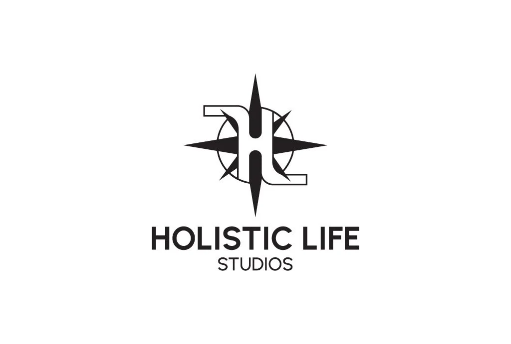 Logo for Holistic Life Studios featuring a black and white compass with a stylized 'H' integrated into the design.