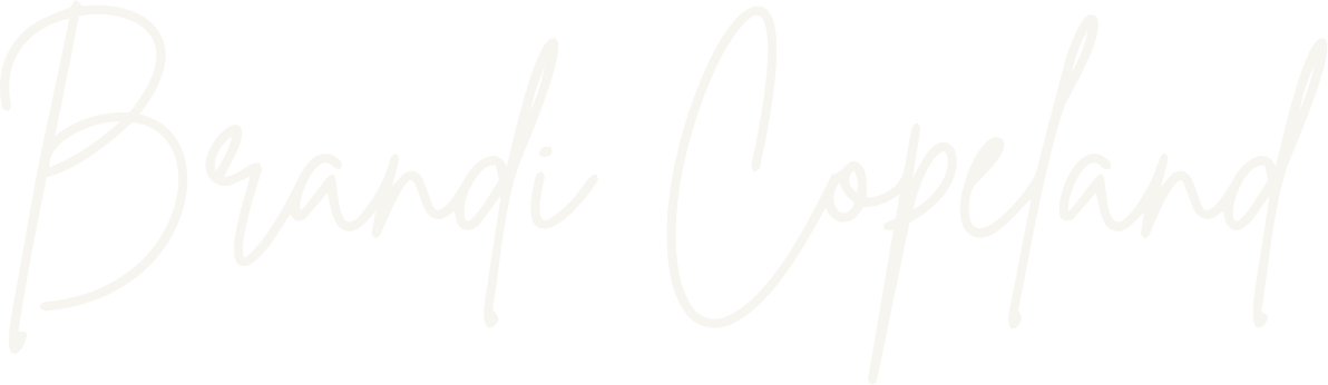 Text that reads 'Brandi Copeland' in white script font on a black background.