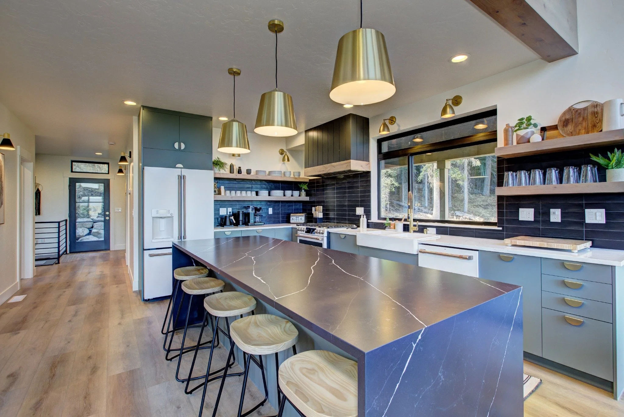 The Wildwood kitchen with a waterfall island, bar seating, and modern finishes