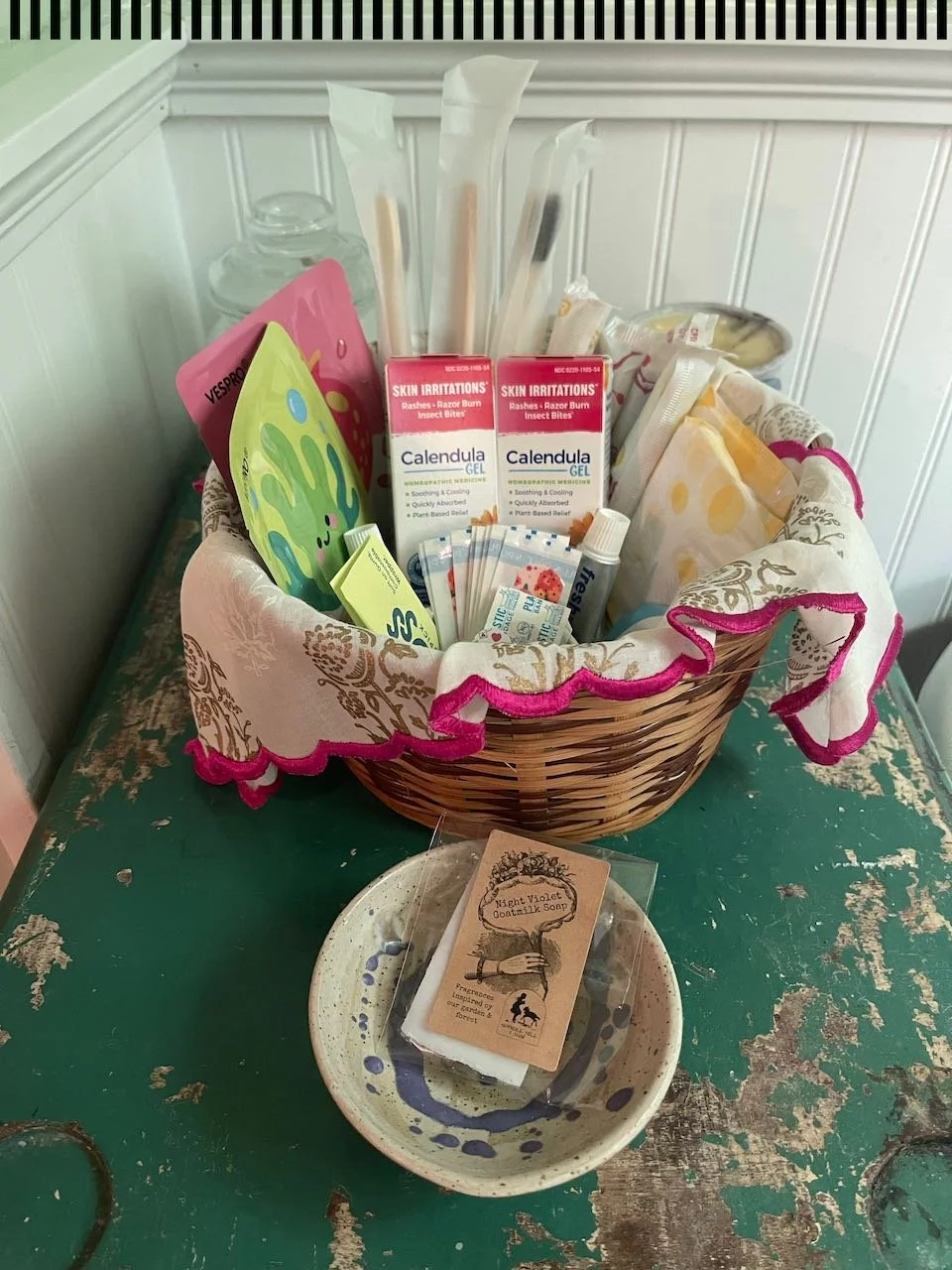 A woven basket stocked with unique products for short term rental Airbnb guests.