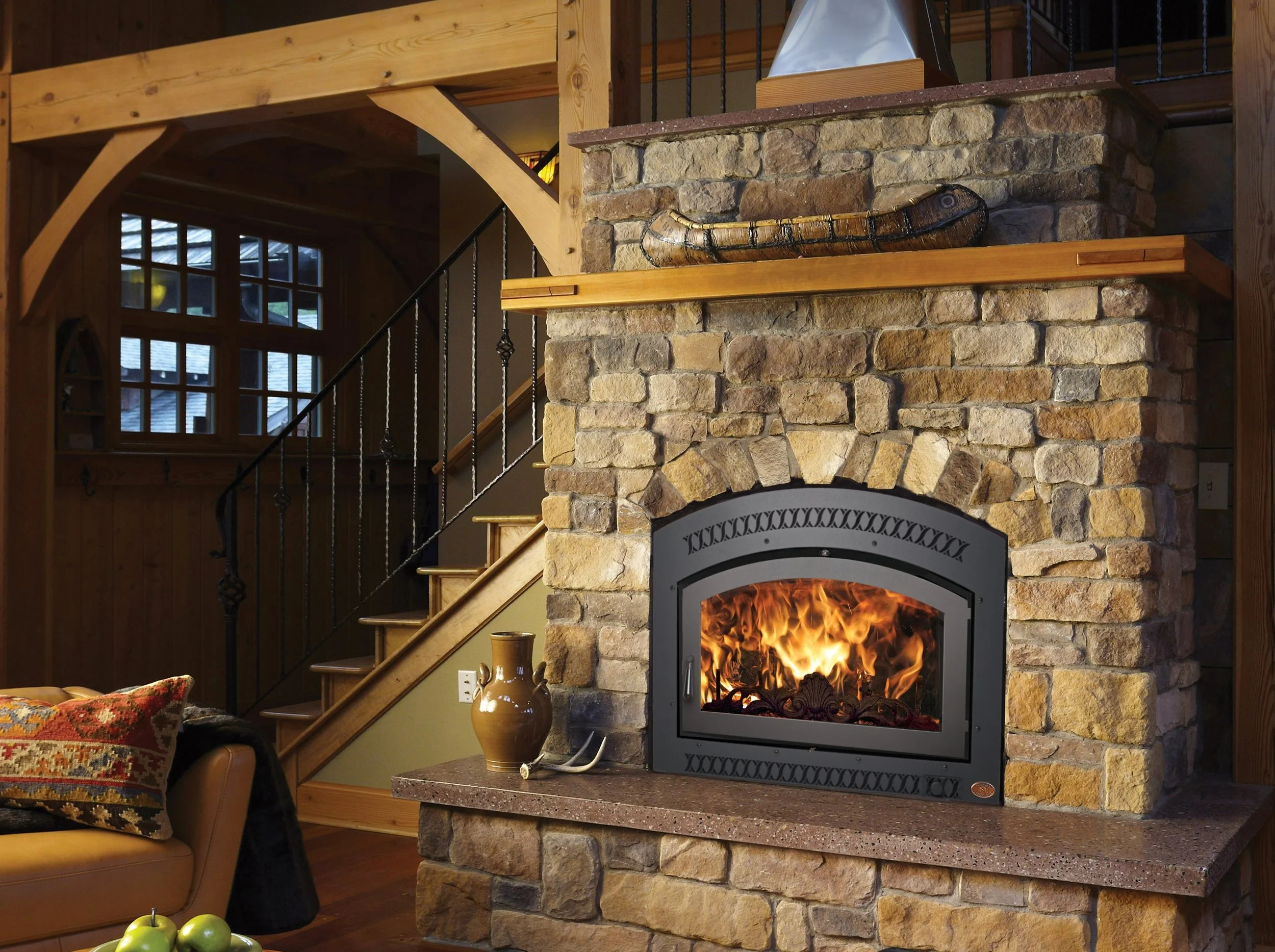 FPX 36 Elite wood fireplace in rustic home against rock wall