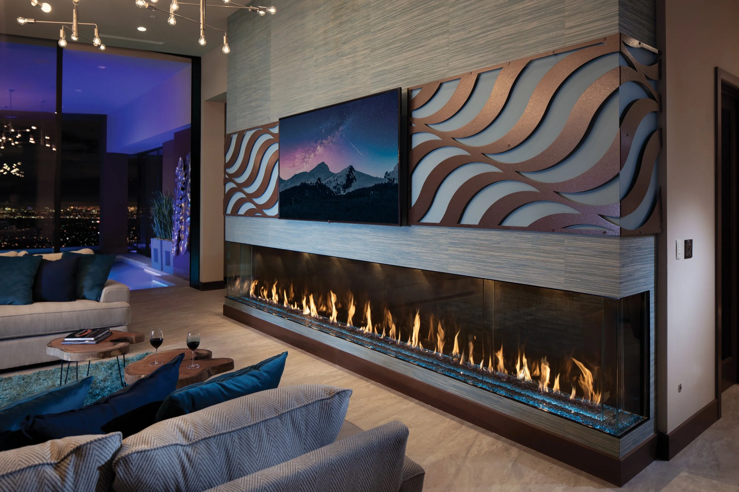 luxury fireplace in high-end house with couches and wine on coffee tables