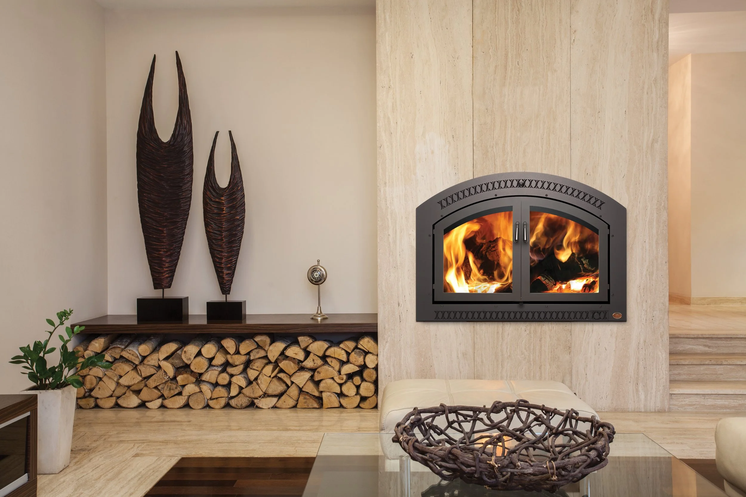 FPX 44 Elite wood fireplace with wood stacked nearby