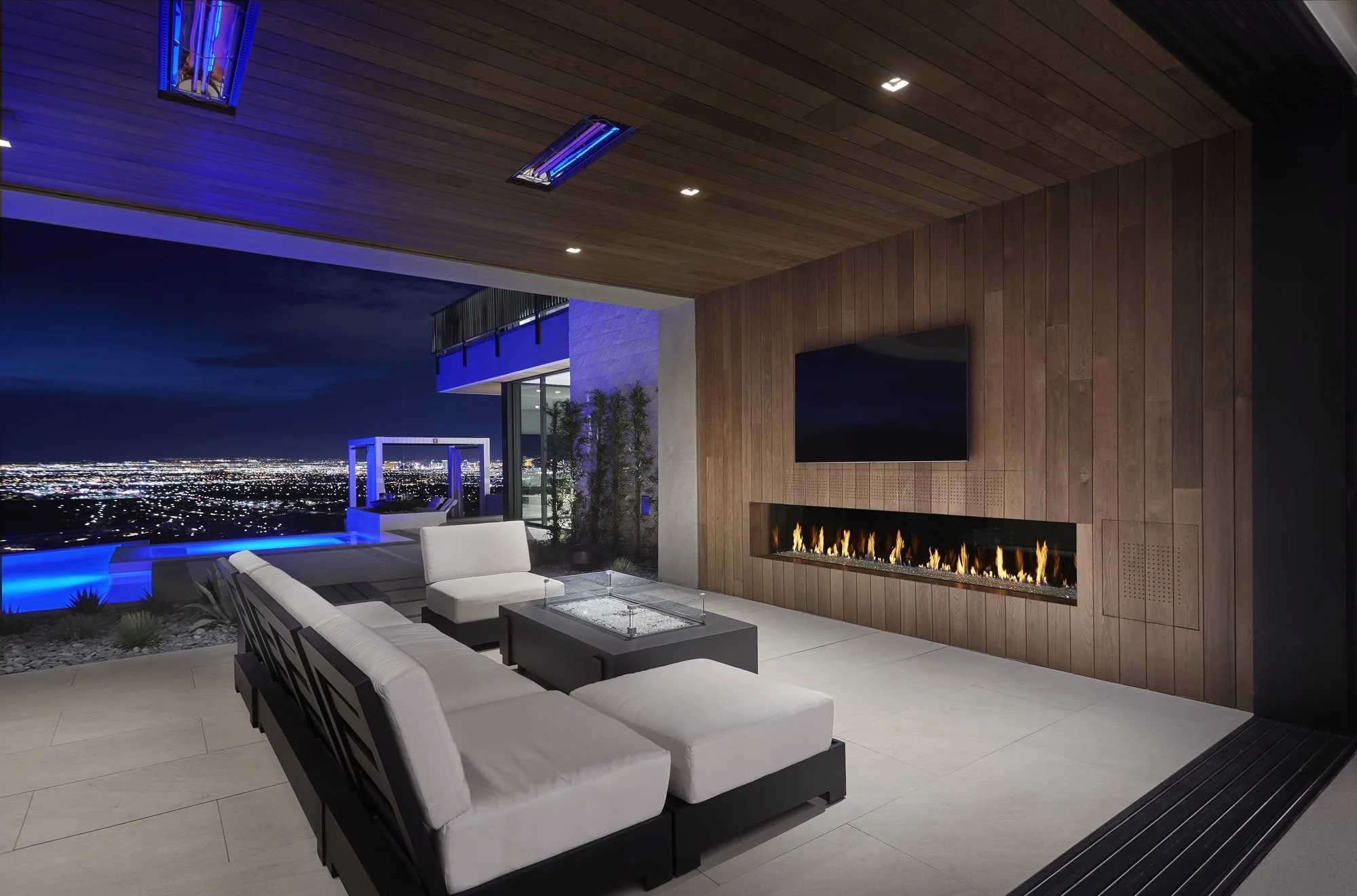 DaVinci 120 x 20 inch single-sided gas fireplace on a covered outdoor patio at night