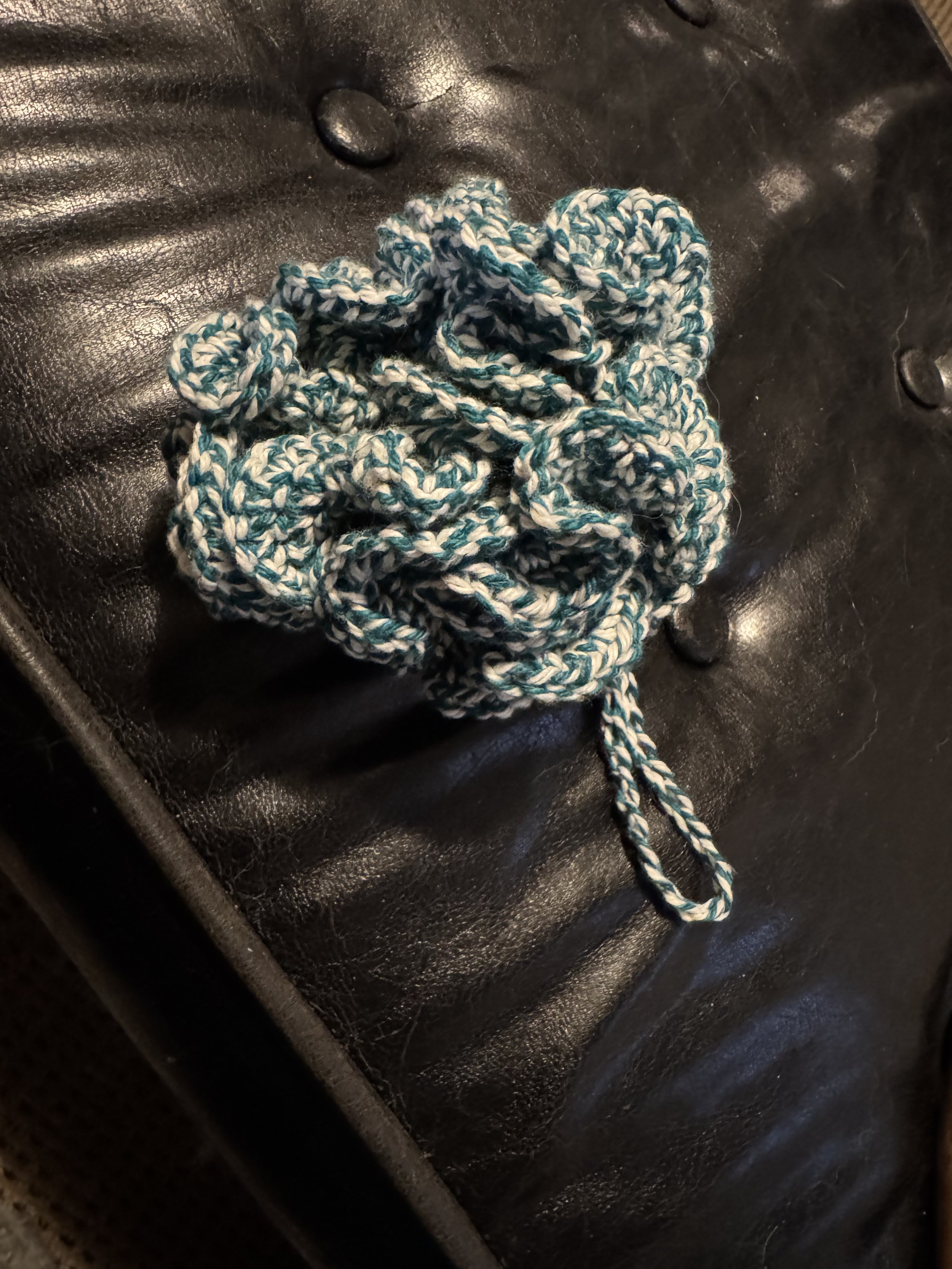 A crocheted cotton shower puff