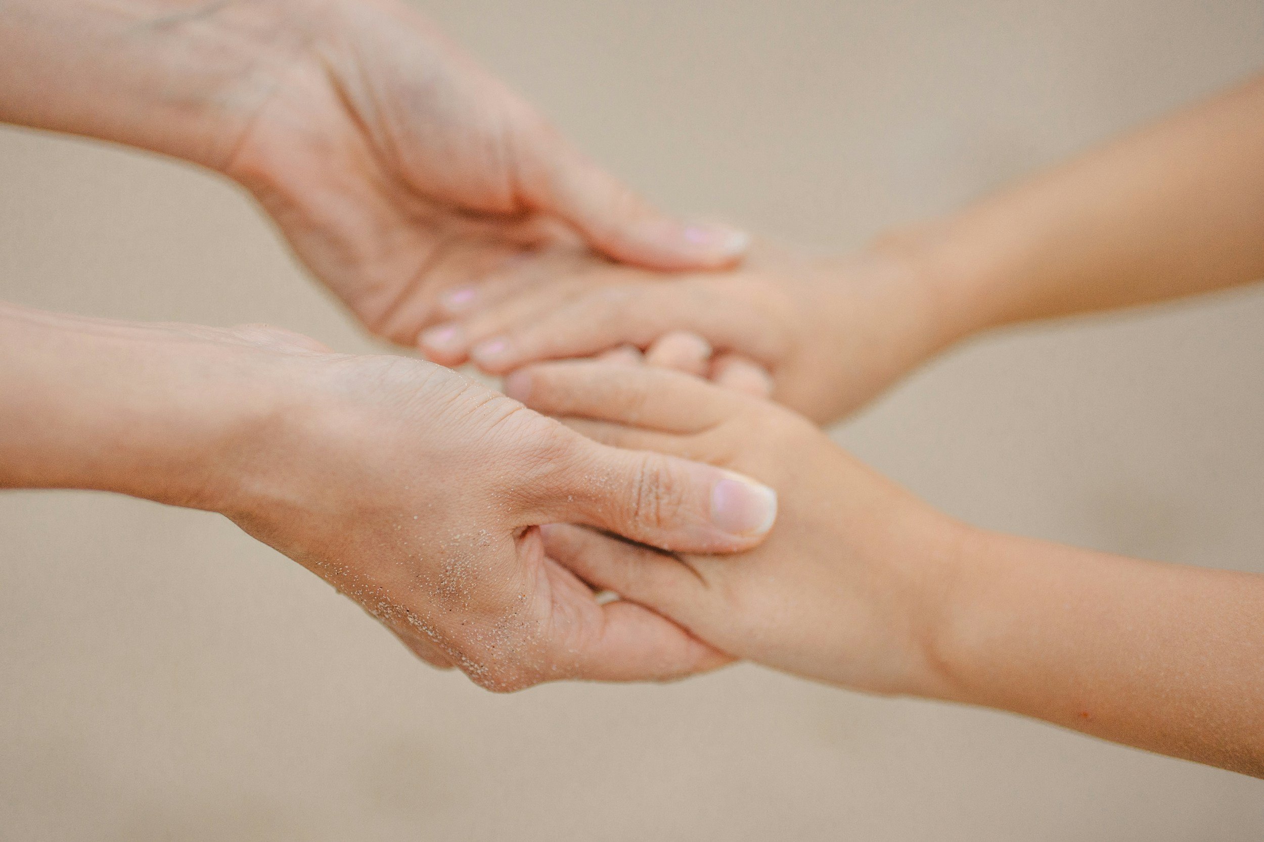 and adult holding both a child's hands, holding steady