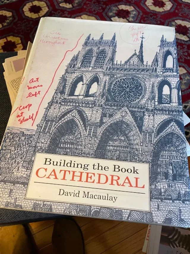 A large format hard cover book, with a drawing of a cathedral on the front.