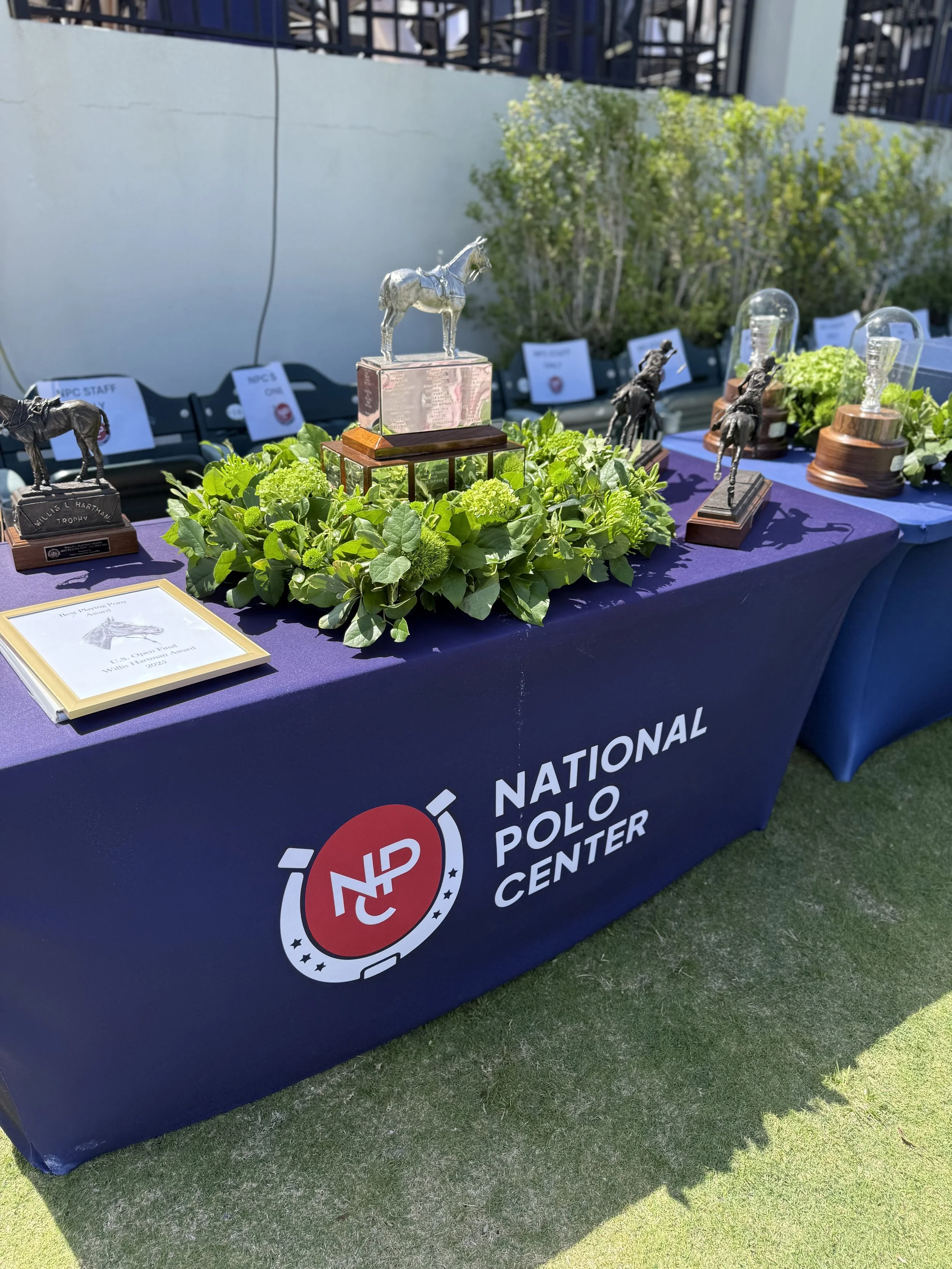 Table with awards and greenery at a National Polio Center event