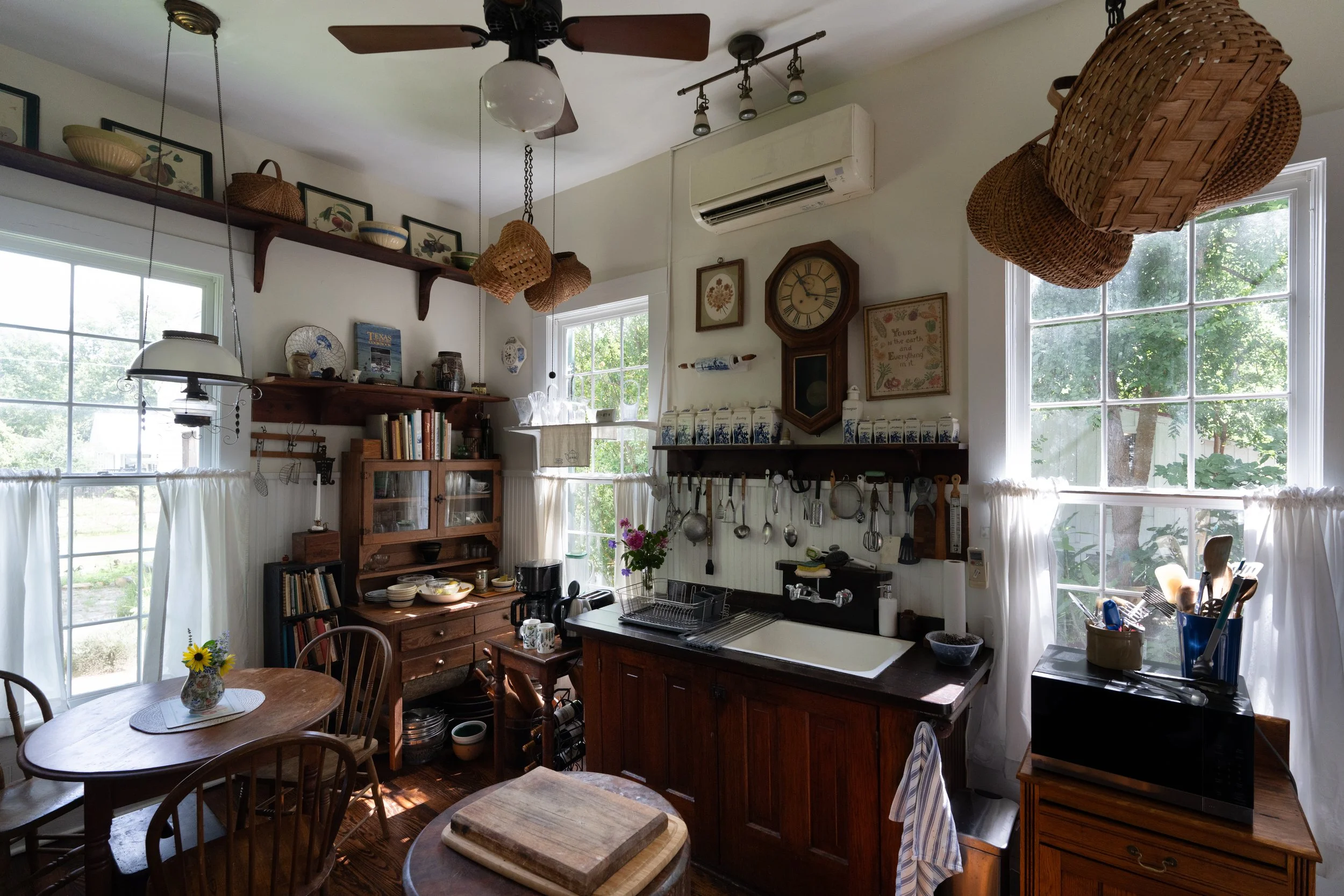 Our inviting kitchen is a wonderful place to cook and gather for morning croissants, breakfast and coffee. Built-in Texas pine cabinets, anique butcher block and vintage cookware/implements add to the overall warmth and ambiance.