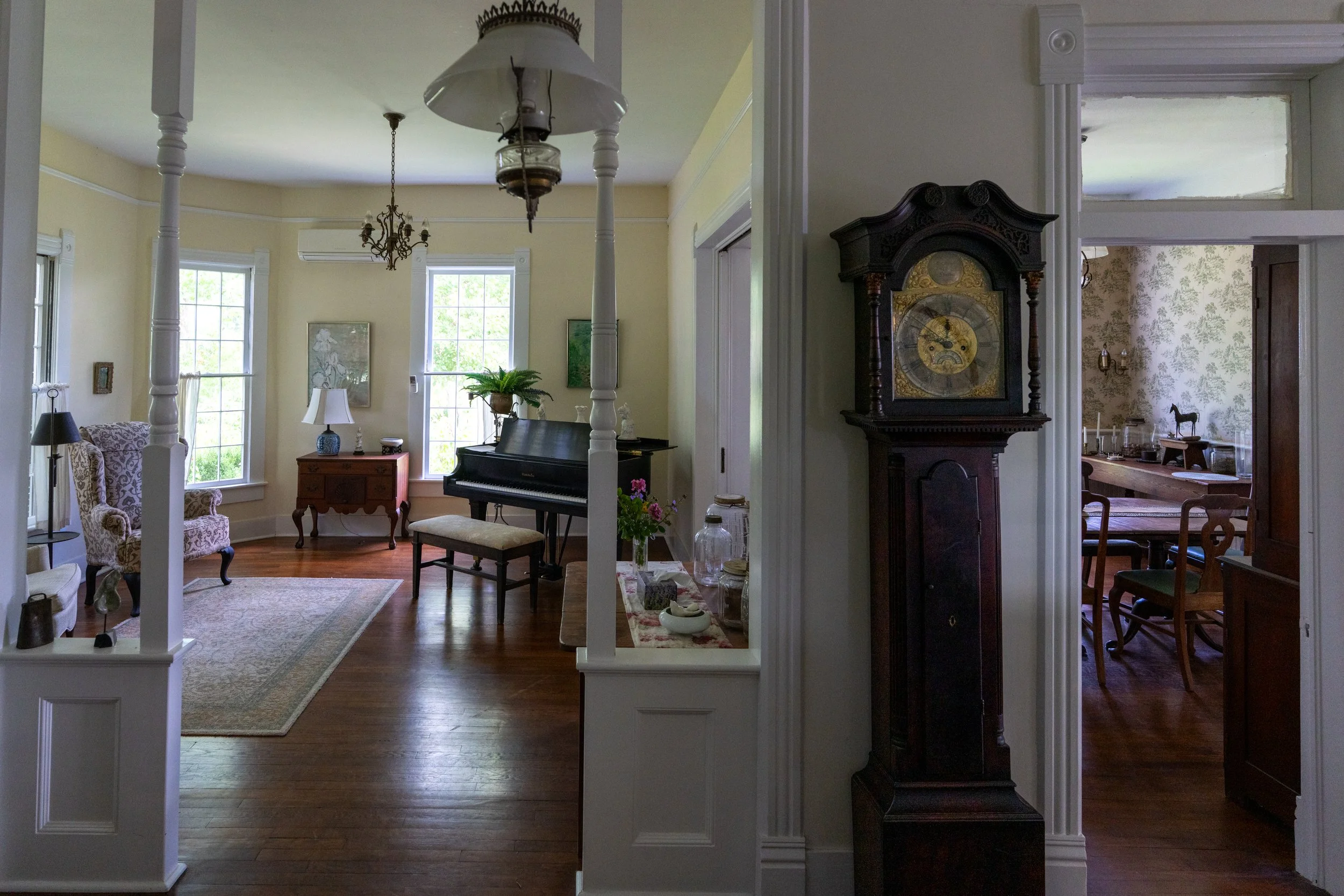 A view of the music room from the front hallway.  The pictures seen throughout the house were painted by the owners' mother Catine Perkins, who created the original gardens and worked to restore the house along with her husband Robert.