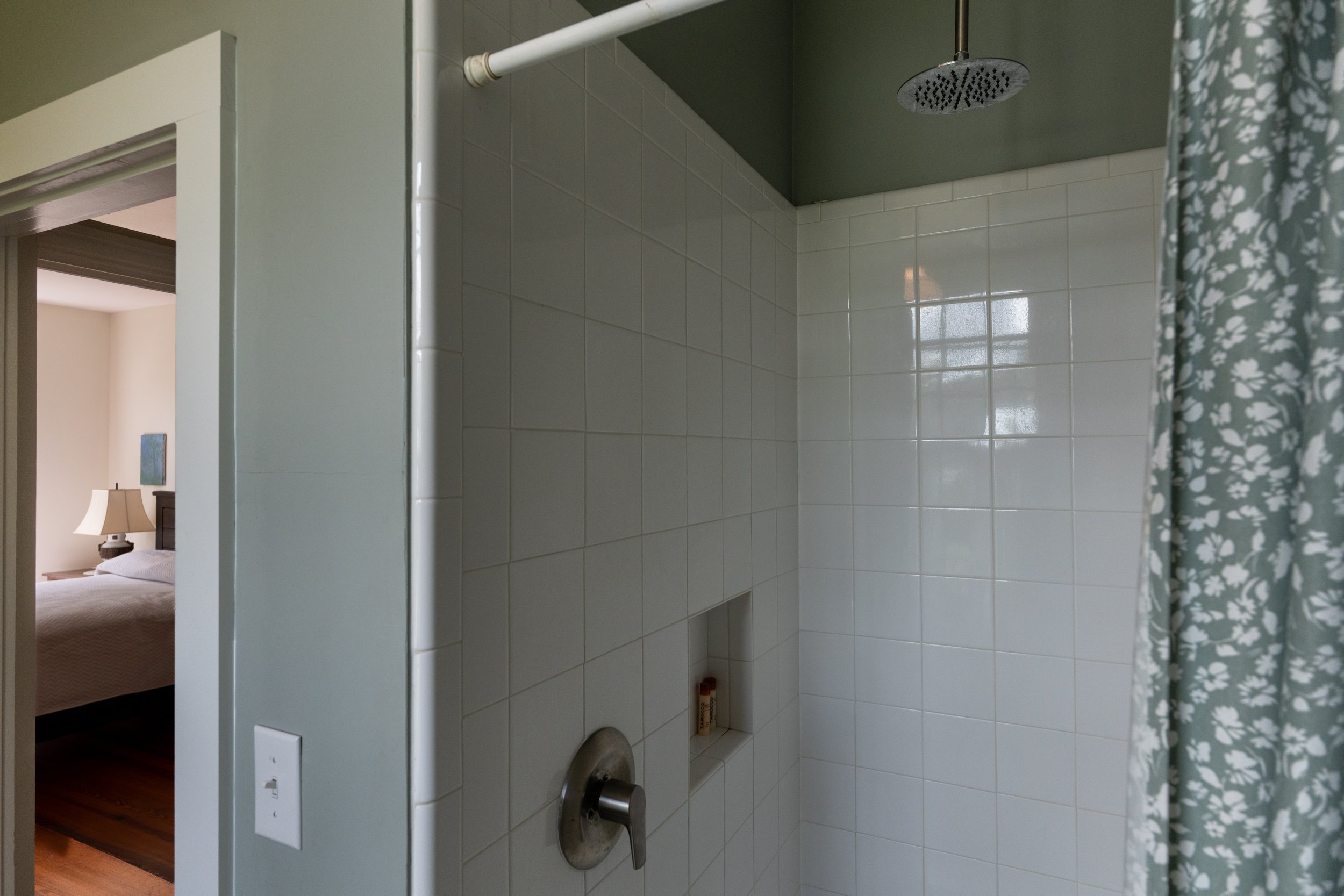View of the walk-in waterfall shower in the second upstairs bathroom.
