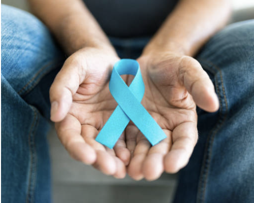 Person holding a blue awareness ribbon in their hands.