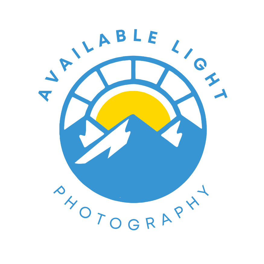Logo with a mountain, sun, and lightning bolts, surrounded by the text 'Available Light Photography'.