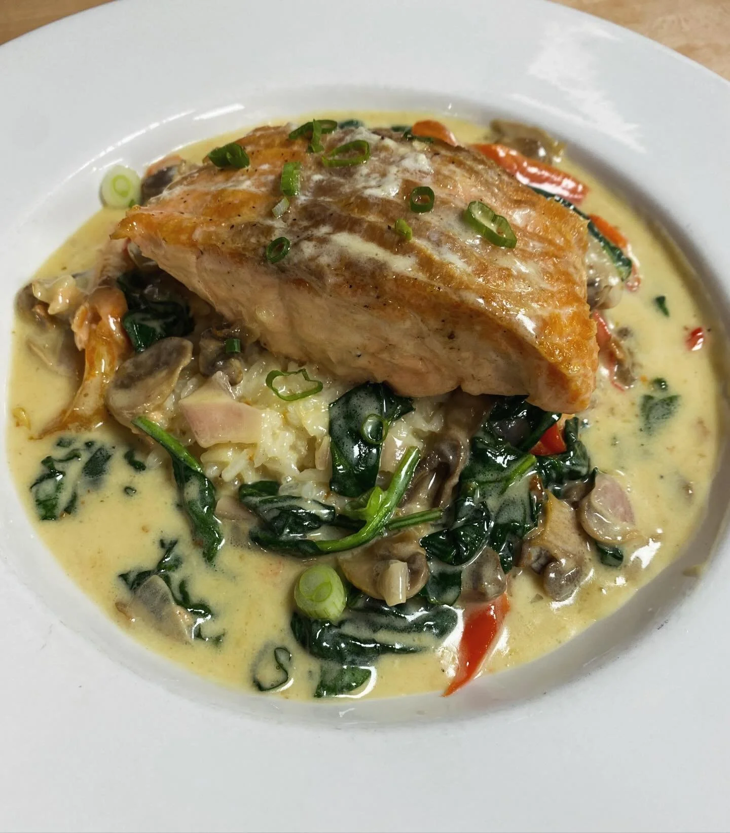 it&rsquo;s a perfect spring evening for a deliciously light dinner special! come enjoy our salmon filet poached in a creamy mixture of red onion, bell pepper, mushroom &amp; spinach, served over fluffy jasmine rice &mdash; beautiful &amp; yummy! see 