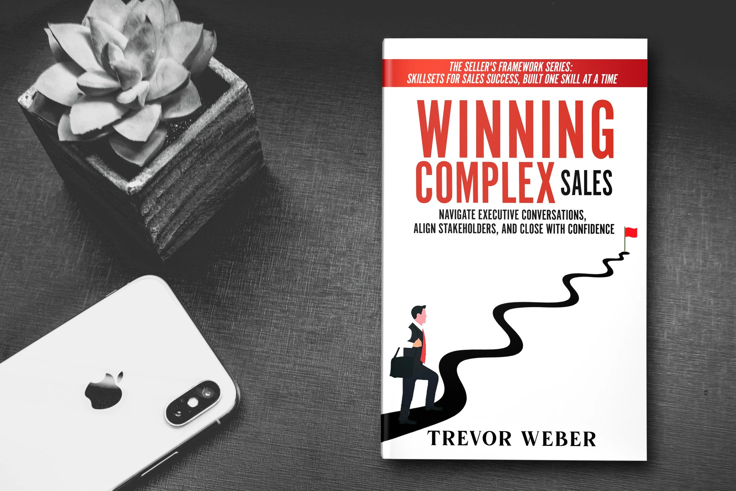 Book titled "Winning Complex Sales" by Trevor Weber, featuring a red, white, and black color scheme with a man walking a winding path to a red flag. Strategies and frameworks for multithreading deals, building value, and closing confidently