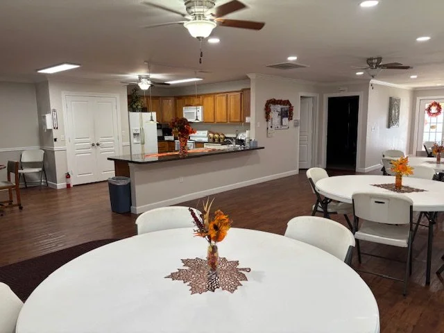 Clubhouse tables and view into kitchen