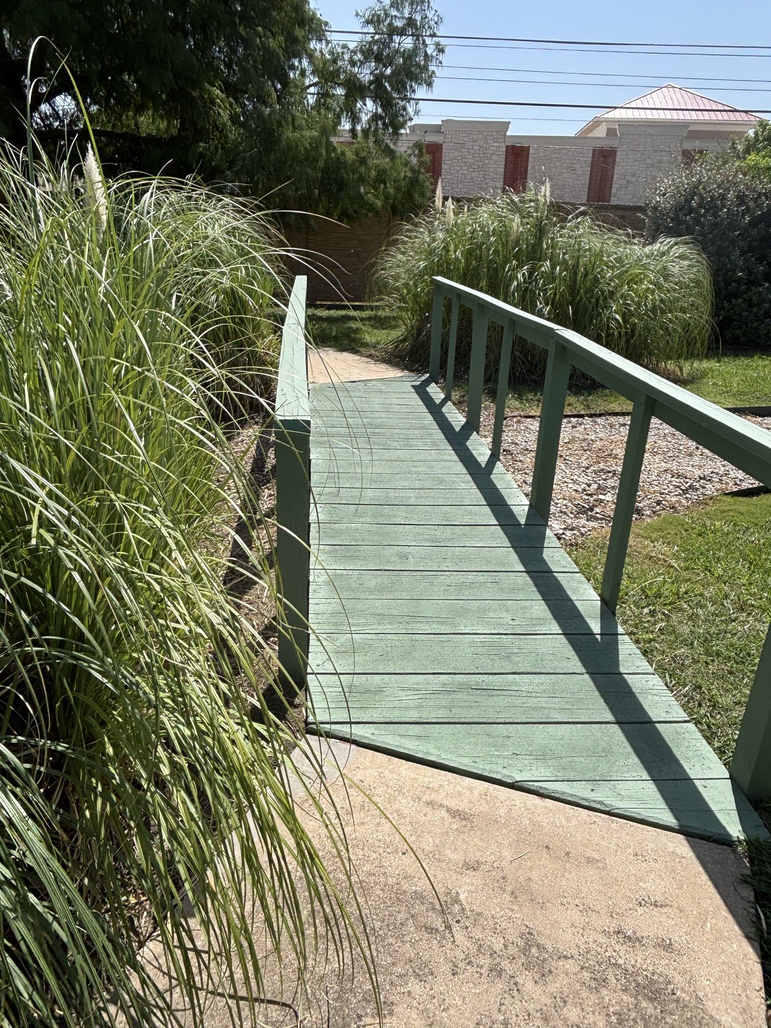 Village bridge along tree-lined pathway