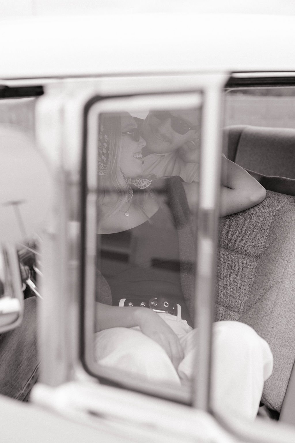 A woman and a child are smiling and looking at each other through a window, captured in a reflection.