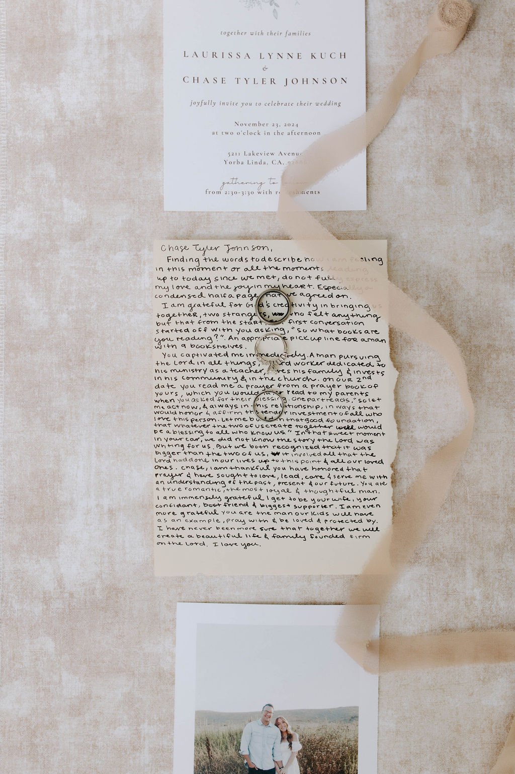 Wedding invitation with handwritten letter and a photograph of a couple outdoors.