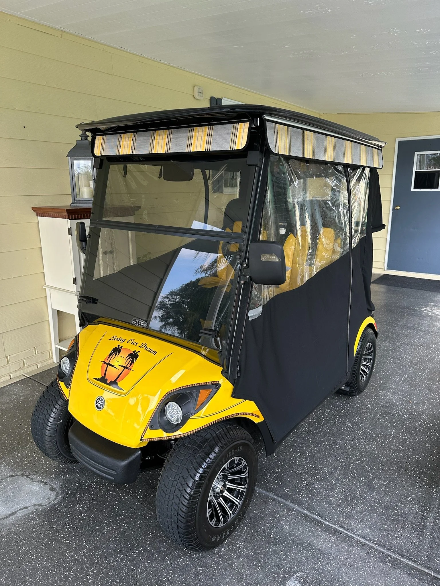 yellow golf cart with rain curtains