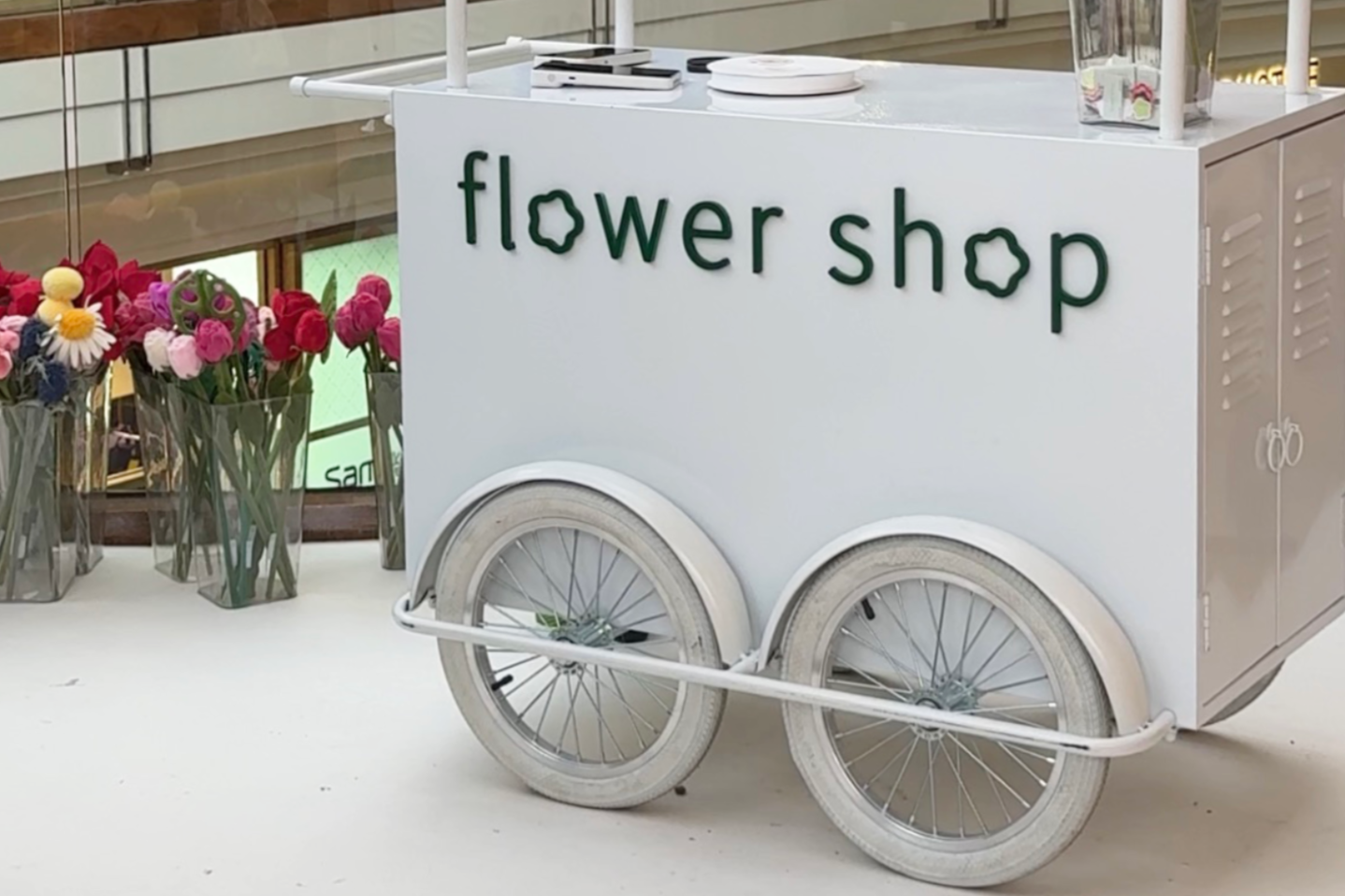 Minimal white flower cart installation photographed by Social Sync AU at CJ Hendry’s Flower Shop experience in Melbourne